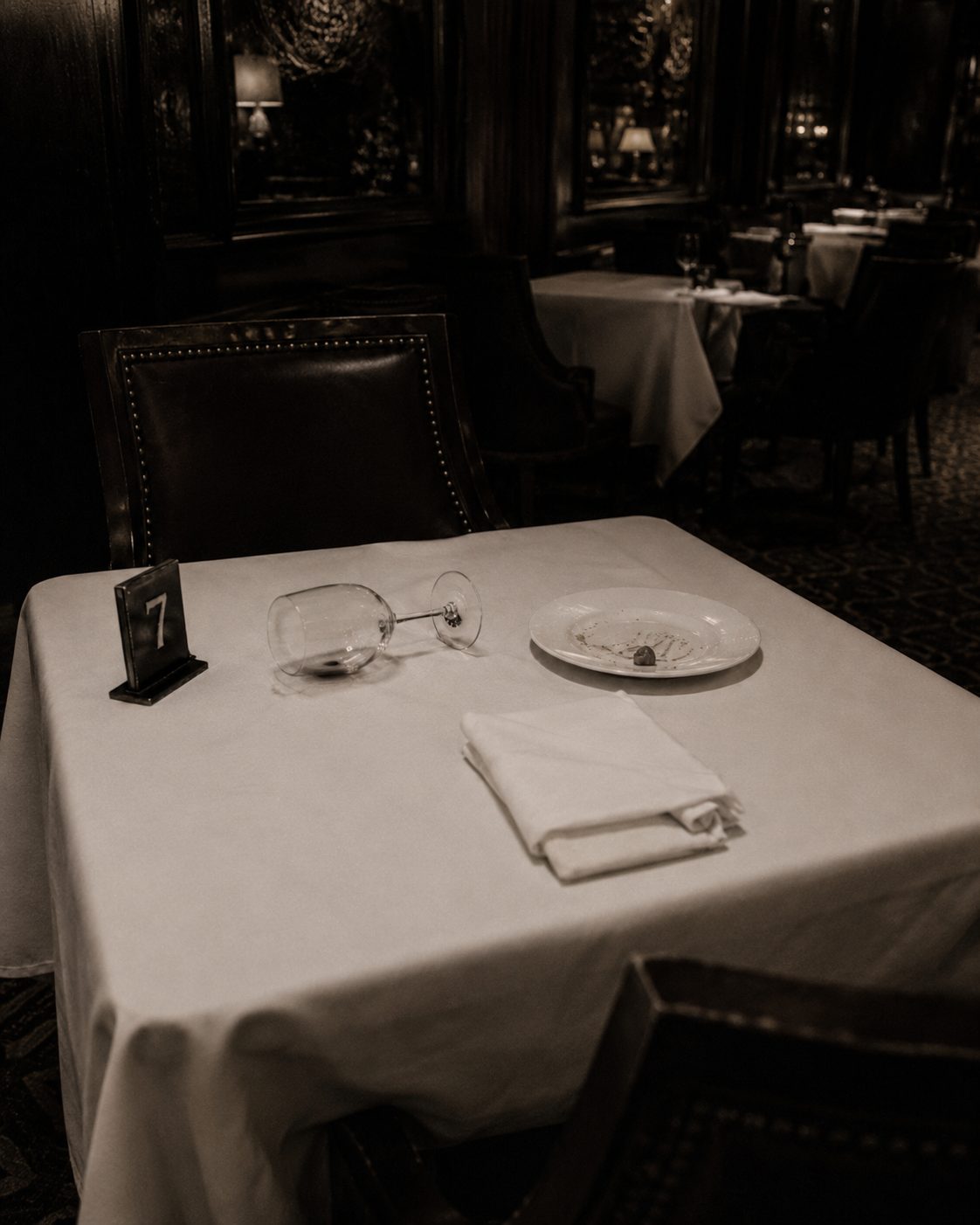 A moody restaurant table set for a mystery date night